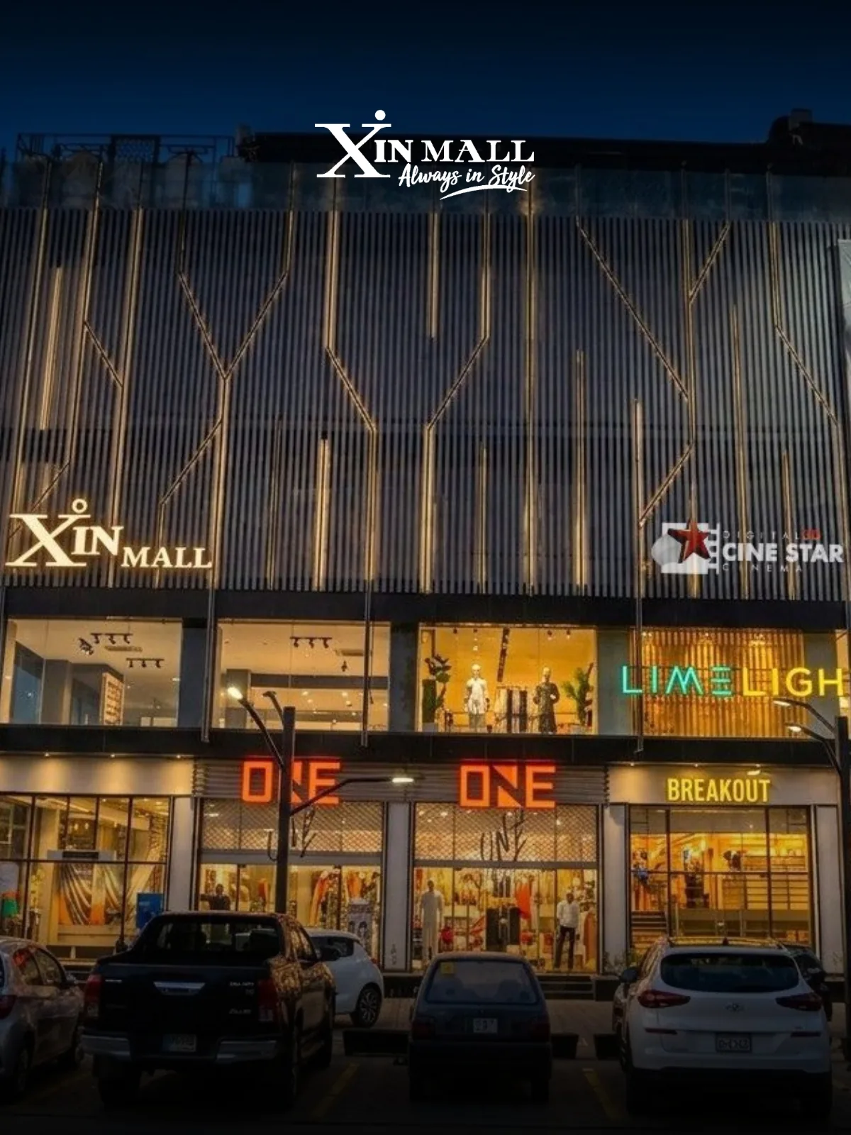 Xin Mall's lit frontage on Queens Road, Sargodha, with ONE, Limelight and BREAKOUT signage